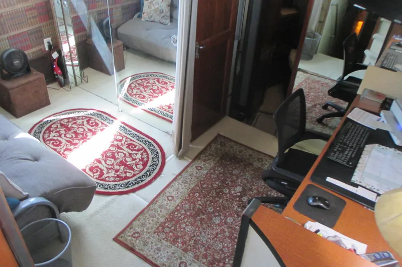 Slide: The Image of Interior of 1981 Hatteras 61 Motor Yacht with wooden ladder and seating area. - 23