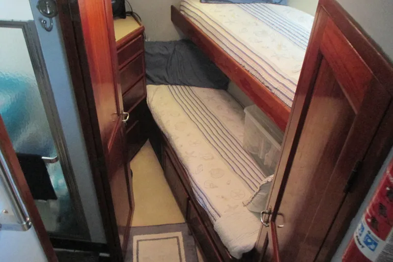 Slide: The Image of 1981 Hatteras 61 Motor Yacht with advanced navigation equipment under a cloudy sky. - 29