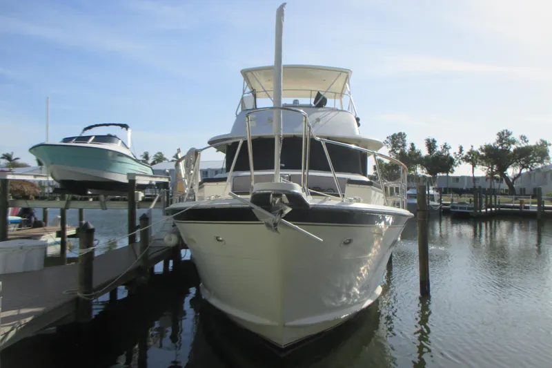 Slide: The Image of 1981 Hatteras 61 Motor Yacht docked in a marina, front view. - 3