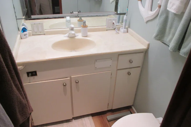 Slide: The Image of Interior of 1981 Hatteras 61 Motor Yacht with rugs, desk, and seating area. - 32