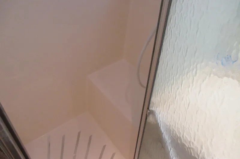 Slide: The Image of Cozy interior of 1981 Hatteras 61 Motor Yacht with sofa, decorative pillows, and patterned rug. - 33