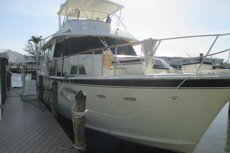Slide: The Image of 1981 Hatteras 61 Motor Yacht docked at marina, side view. - 4