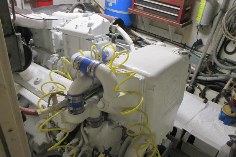 Slide: The Image of Engine room of 1981 Hatteras 61 Motor Yacht with visible machinery and hoses. - 51