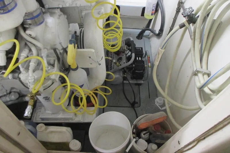 Slide: The Image of Engine room of 1981 Hatteras 61 Motor Yacht with hoses and maintenance tools. - 53