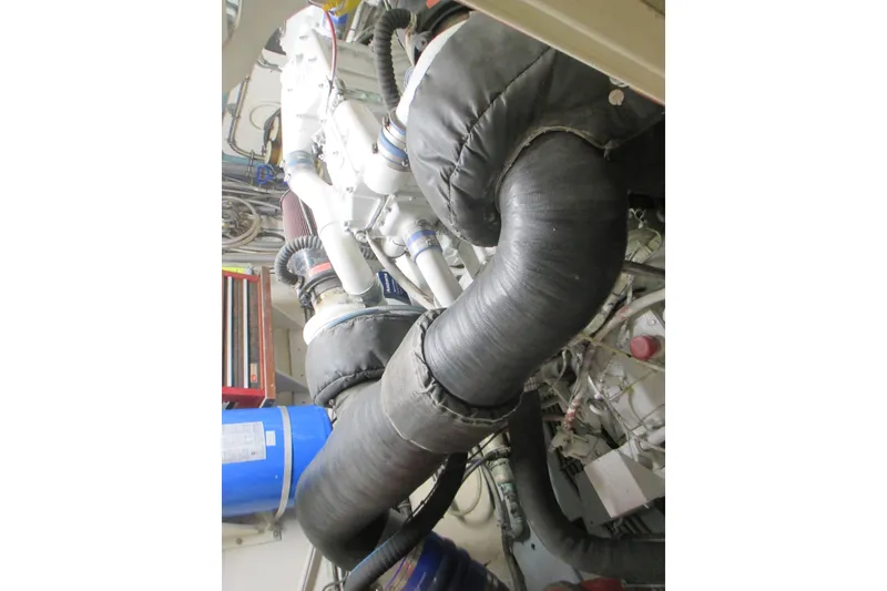 Slide: The Image of Engine room of 1981 Hatteras 61 Motor Yacht with insulated pipes and machinery. - 54