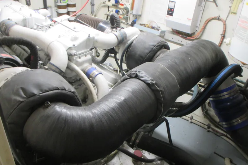 Slide: The Image of Engine room of 1981 Hatteras 61 Motor Yacht with insulated pipes and machinery. - 57