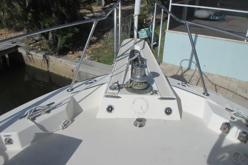 Slide: The Image of Bow of 1981 Hatteras 61 Motor Yacht with anchor winch and railing. - 7