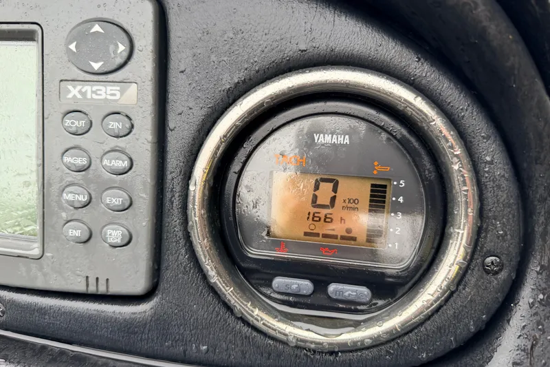 Slide: The Image of Close-up of Yamaha tachometer and X135 display on 2006 Skeeter 20i boat dashboard. - 10