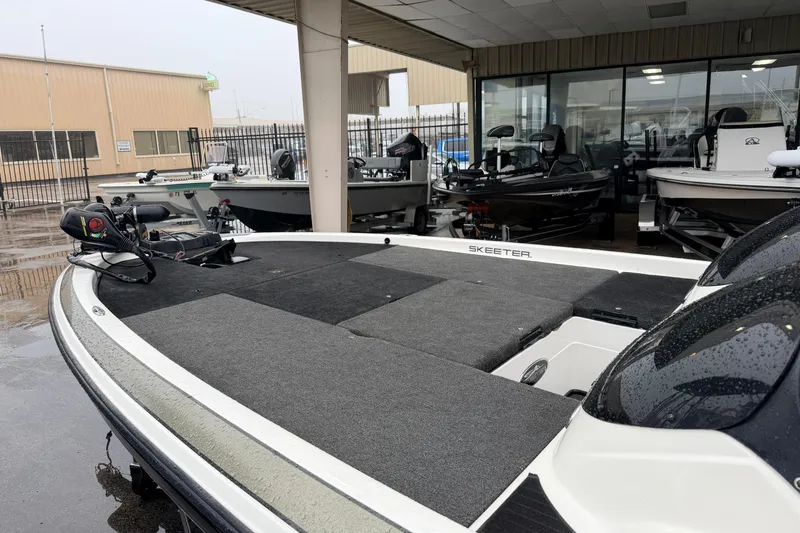 Slide: The Image of 2006 Skeeter 20i bass boat displayed at a dealership, featuring a spacious deck. - 6