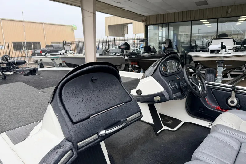 Slide: The Image of 2006 Skeeter 20i boat interior with steering wheel and dashboard, displayed in a showroom. - 8