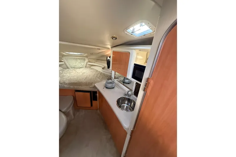 Slide: The Image of Interior of 2000 Regal Commodore 2760 boat with kitchenette and sleeping area. - 10