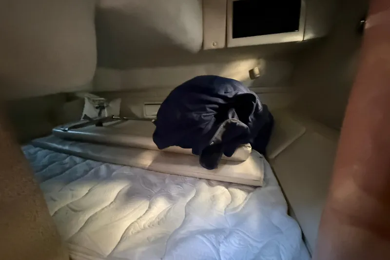 Slide: The Image of Interior cabin of 2000 Regal Commodore 2760 with bedding and storage. - 12