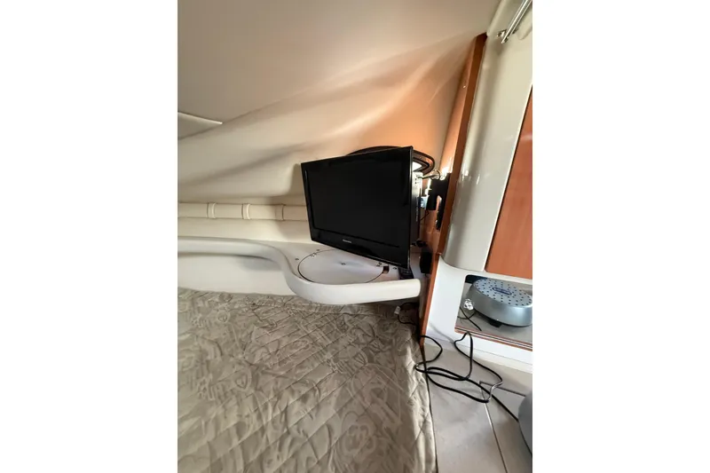 Slide: The Image of Interior of 2000 Regal Commodore 2760 with TV and cozy bedding. - 14