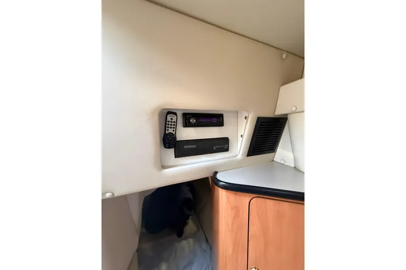 Slide: The Image of 2000 Regal Commodore 2760 cabin interior with Kenwood stereo system and remote control. - 15