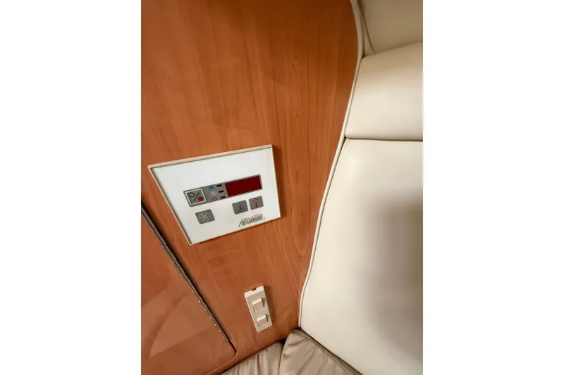 Slide: The Image of Control panel on 2000 Regal Commodore 2760 boat interior, featuring wood and leather accents. - 16
