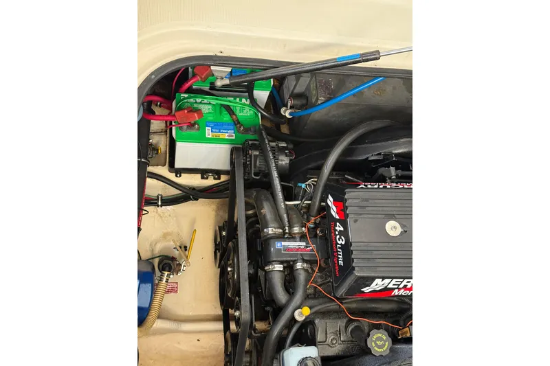 Slide: The Image of Engine compartment of a 2000 Regal Commodore 2760 boat with visible battery and wiring. - 18