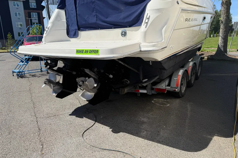 Slide: The Image of 2000 Regal Commodore 2760 boat on trailer, rear view, "Make an Offer" sign visible. - 21