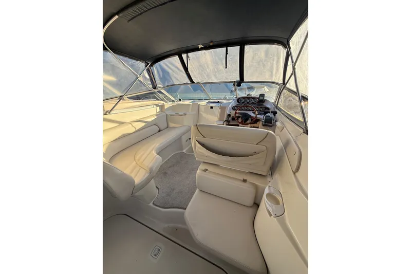 Slide: The Image of 2000 Regal Commodore 2760 boat interior with seating and helm, under canopy. - 3