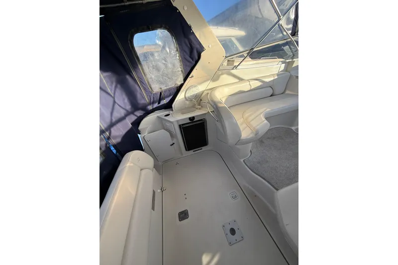 Slide: The Image of Interior of 2000 Regal Commodore 2760 boat with seating and window view. - 4