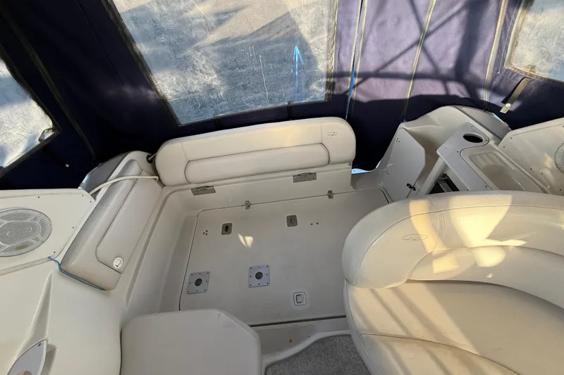 Slide: The Image of Interior of a 2000 Regal Commodore 2760 boat with beige seating and blue canopy. - 6