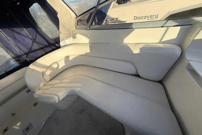 Slide: The Image of Interior seating of 2000 Regal Commodore 2760 boat, featuring cream-colored upholstery. - 8