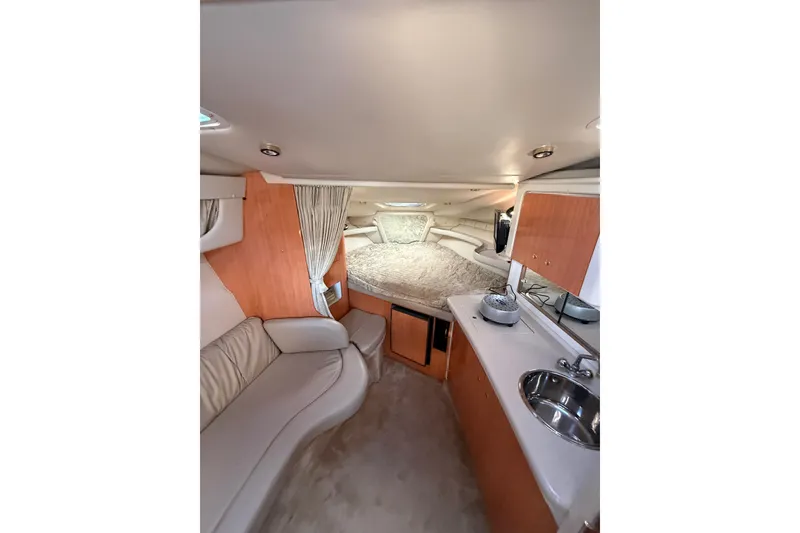 Slide: The Image of Interior of 2000 Regal Commodore 2760 boat with cozy seating and compact kitchenette. - 9