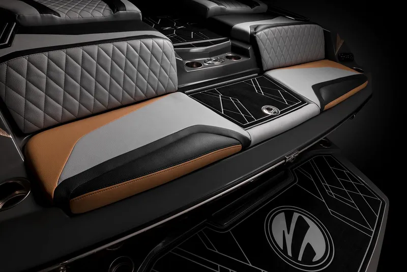 Slide: The Image of 2023 Tigé 23ZX boat in vibrant teal, parked on a trailer under a blue sky. - 10