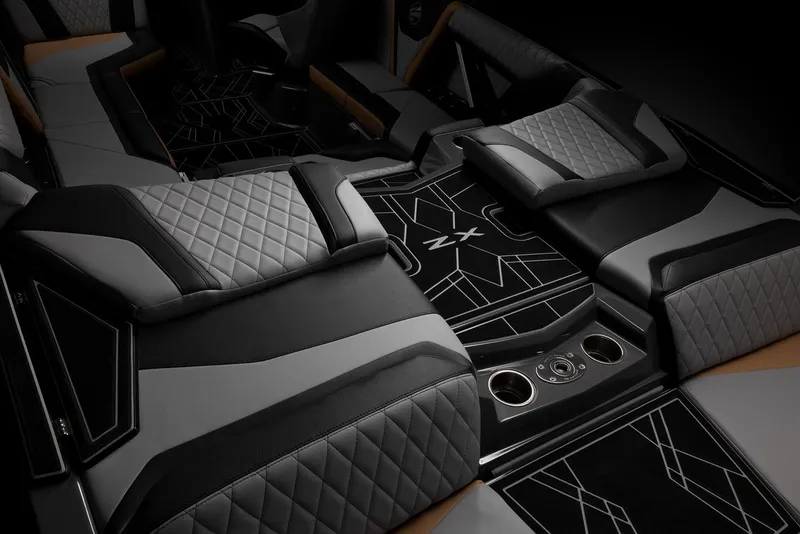 Slide: The Image of 2023 Tigé 23ZX boat with teal and black exterior, tan seating, under a clear blue sky. - 12