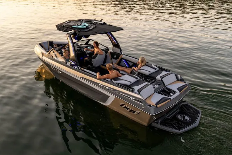 Slide: The Image of 2023 Tigé 23ZX boat on trailer, vibrant teal and black design, parked outdoors. - 2