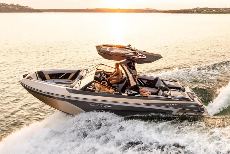 Slide: The Image of 2023 Tigé 23ZX boat on trailer, vibrant teal color, sunny day background. - 3