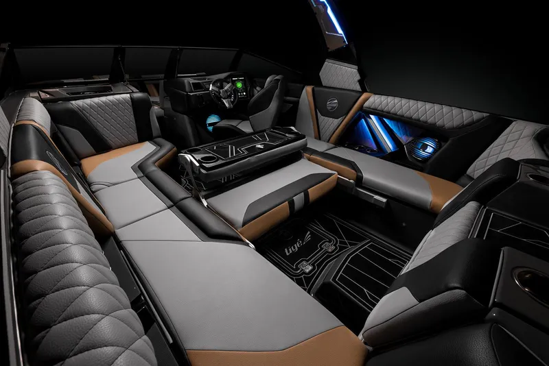 Slide: The Image of 2023 Tigé 23ZX boat with sleek black and turquoise design under a clear blue sky. - 7