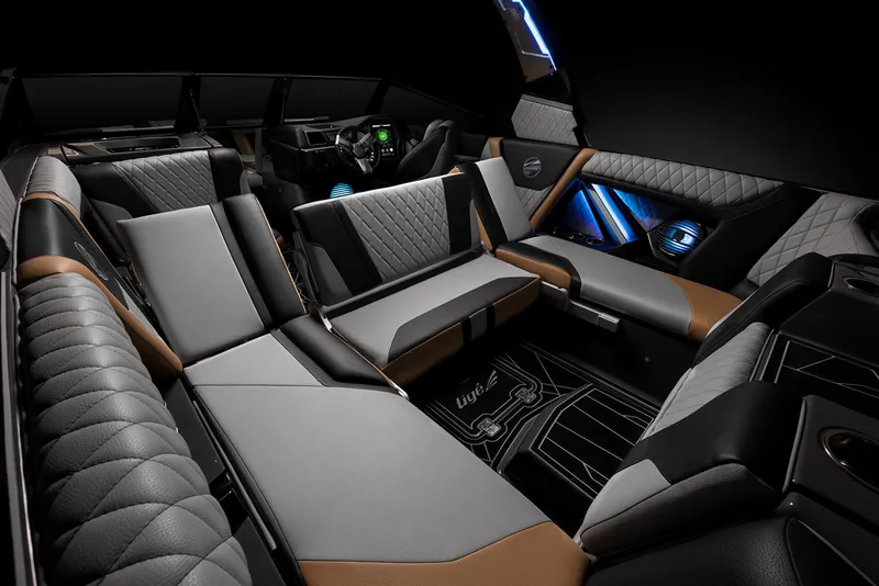 Slide: The Image of 2023 Tigé 23ZX boat with sleek black and turquoise design under a clear blue sky. - 8