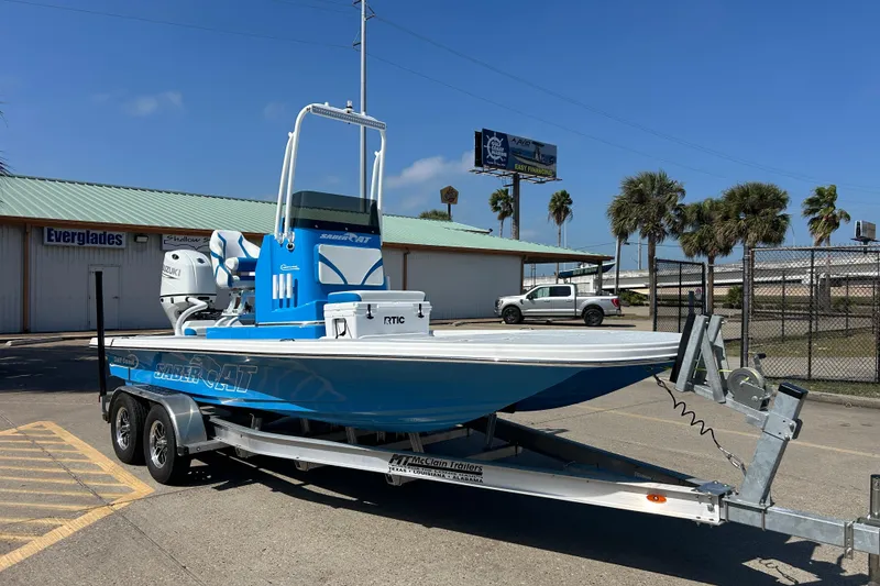 Slide: The Image of 2026 Gulf Coast Saber Cat boat on trailer, parked outdoors under clear sky. - 3