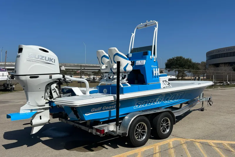 Slide: The Image of 2026 Gulf Coast Saber Cat boat with Suzuki engine on trailer. - 5