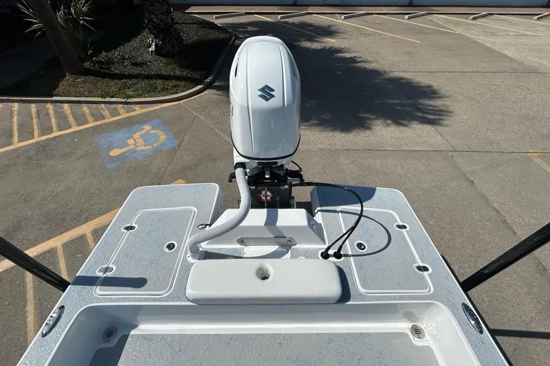 Slide: The Image of 2026 Gulf Coast Saber Cat boat with outboard motor in parking lot. - 7