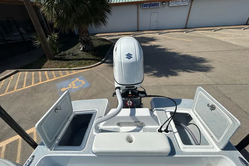 Slide: The Image of 2026 Gulf Coast Saber Cat boat with Suzuki outboard motor, open storage compartments. - 8