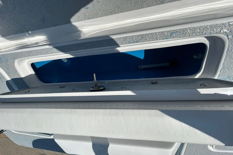 Slide: The Image of Open storage compartment on 2026 Gulf Coast Saber Cat boat. - 9