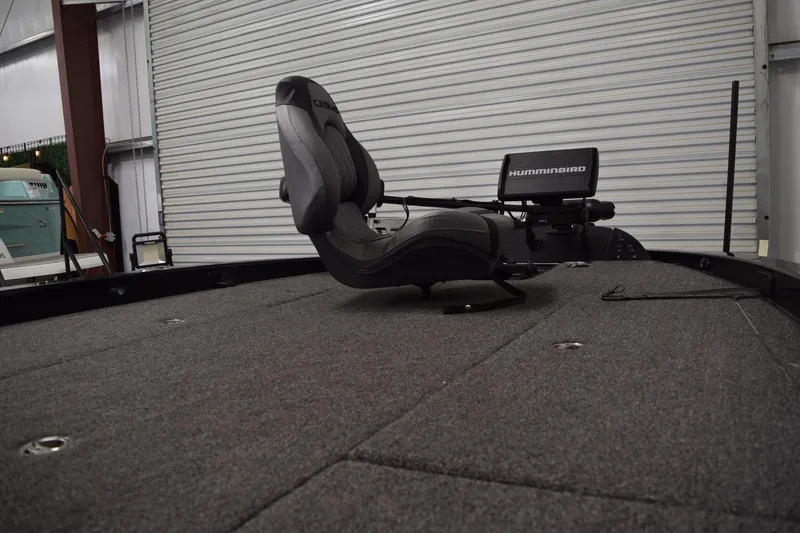 Slide: The Image of 2024 Caymas CX 21 PRO boat interior with Humminbird electronics and cushioned seating. - 11