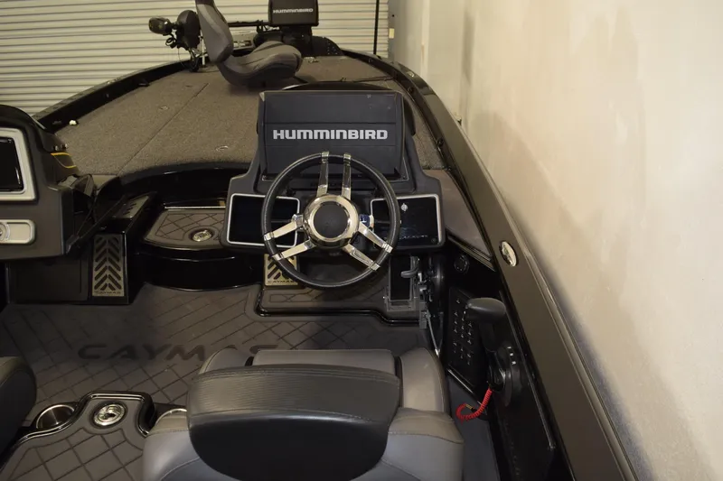Slide: The Image of 2024 Caymas CX 21 PRO boat interior with steering wheel and Humminbird electronics. - 14