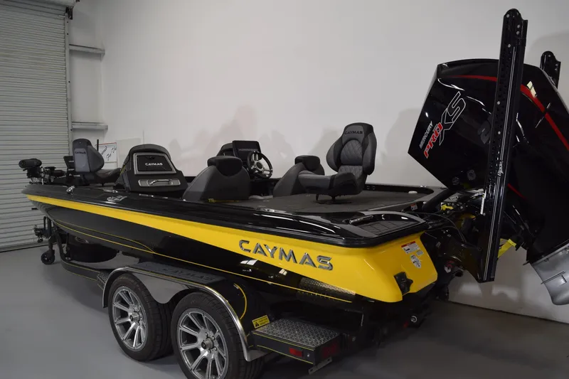 Slide: The Image of 2024 Caymas CX 21 PRO boat, yellow and black, in a showroom setting. - 3
