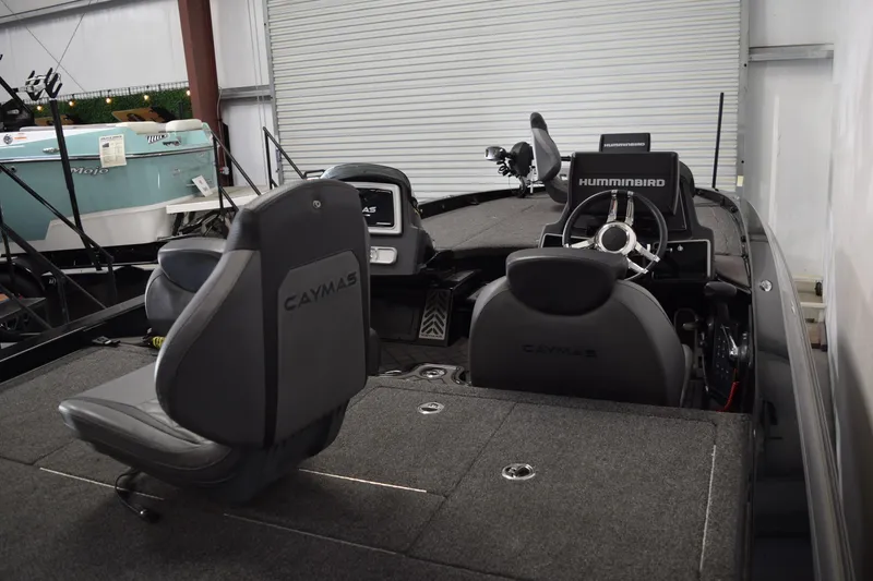 Slide: The Image of 2024 Caymas CX 21 PRO boat interior with steering wheel and seating. - 7