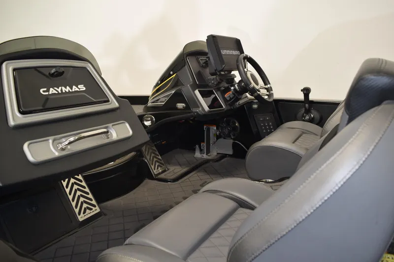 Slide: The Image of 2024 Caymas CX 21 PRO boat interior with steering console and seating. - 9