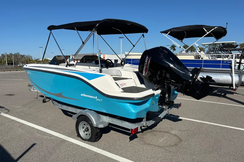 Slide: The Image of 2023 Bayliner Element M17 boat with Mercury outboard motor in a parking lot. - 3