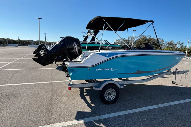Slide: The Image of 2023 Bayliner Element M17 boat on trailer in parking lot, sunny day. - 5