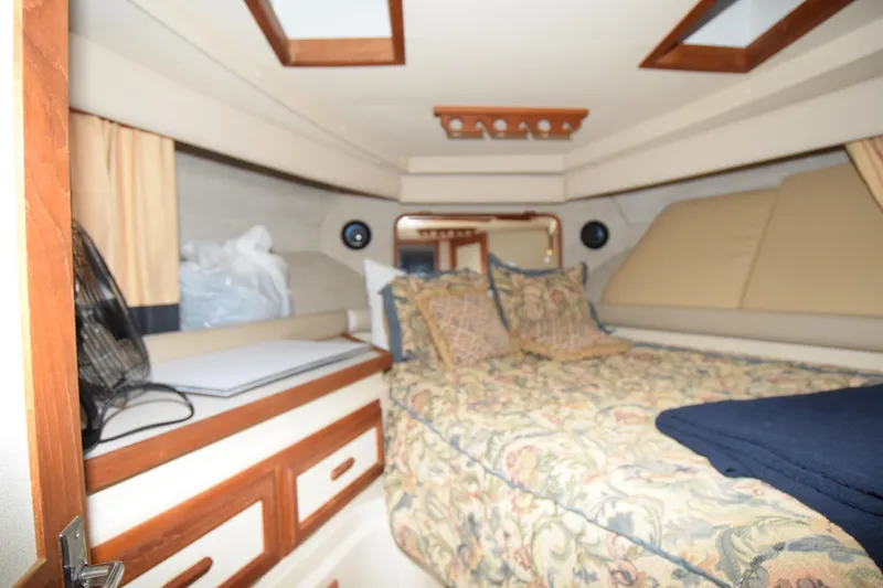 Slide: The Image of 1989 Carver 3297 Mariner cabin interior with bed and storage drawers. - 10
