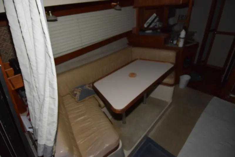 Slide: The Image of 1989 Carver 3297 Mariner interior with beige seating and dining table. - 12