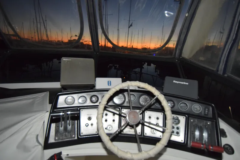 Slide: The Image of 1989 Carver 3297 Mariner helm with sunset view through windows. - 13