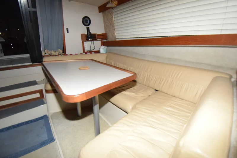Slide: The Image of Interior of 1989 Carver 3297 Mariner with beige seating and dining table. - 2