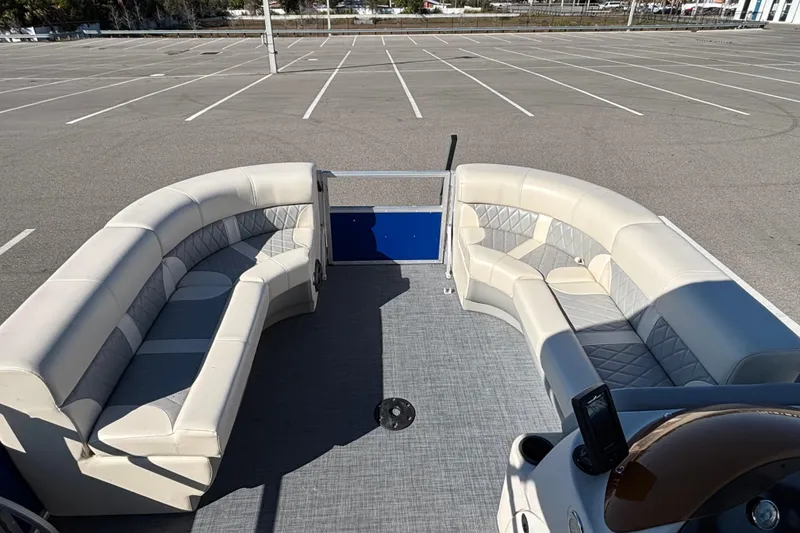 Slide: The Image of 2023 Lexington 321 Fish pontoon boat with spacious seating in an empty parking lot. - 10