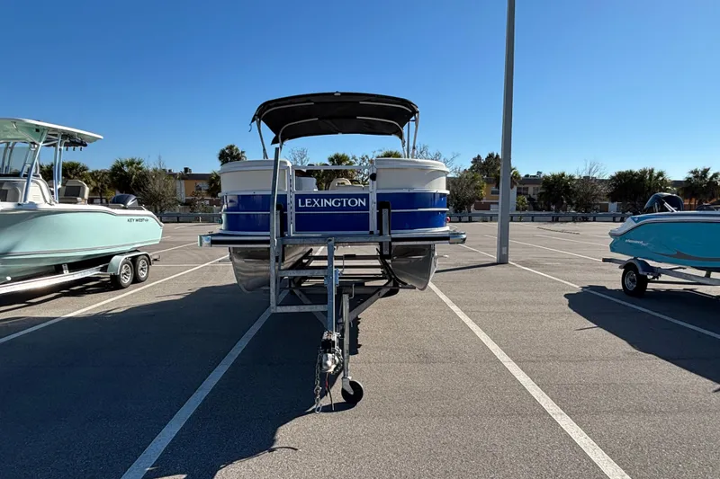 Slide: The Image of 2023 Lexington 321 Fish boat on trailer in parking lot, sunny day. - 3